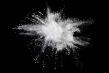 Wall Mural - freeze motion of white color powder exploding on black background.