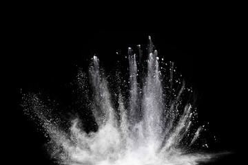 Freeze motion of white color powder exploding on black  background.