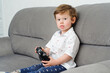 © yana_novak22 - little boy with red hair at home, playing on the couch.