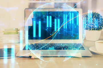 Double exposure of chart and financial info and work space with computer background. Concept of international online trading.