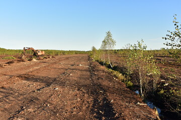 Landscape on peatlands where being development of the peat. Drainage of peat bogs at extraction site. Drilling on bog for oil exploration. Wetlands declining and under threat.