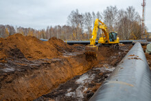 Laying The Pipeline With An Excavator. Autumn, Shooting From A Drone. Earthworks, Infrastructure Construction