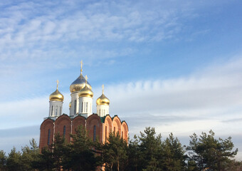 Orthodox Church with Golden domes against the blue sky. Christianity, faith and Orthodoxy.