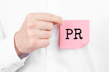 Poster - Man attaches a red sticker with text PR overlay to his white shirt