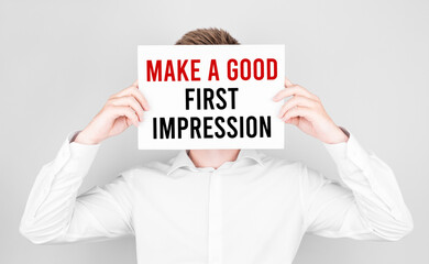 Poster - man covers his face with a white paper with text make a good first impression