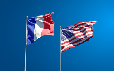 Beautiful national state flags of France and USA together at the sky background. 3D artwork concept.