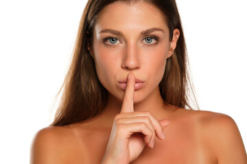  Young woman with finger on her lips