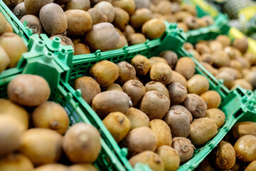 Wall Mural - Kiwi on a supermarket showcase in the vegetable section
