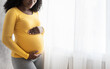 © Prostock-studio - Cropped of black pregnant lady standing by window