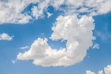 Wall Mural - Single white cloud in a shape like a circle against beautiful blue sky in the centre of the image