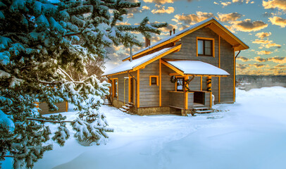 Vacation home. The cottage is covered in snow. Snowdrifts near the cottage. House away from the city. Concept - Christmas holiday away from the city. Northern nature. Wooden cottage on a winter day