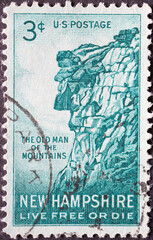 Wall Mural - USA - Circa 1955 : a postage stamp printed in the US showing the Old Man of the Mountain.New Hampshire Text: Live free or die