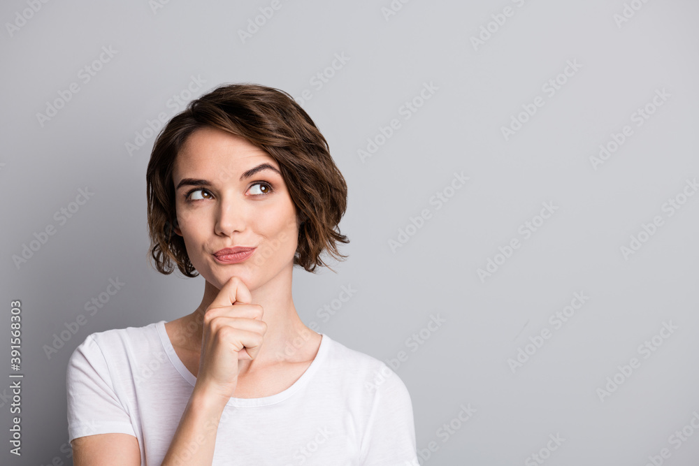 Portrait of young curious thoughtful beautiful girl woman female look in copyspace hold hand on chin isolated on grey color background - obrazy, fototapety, plakaty 