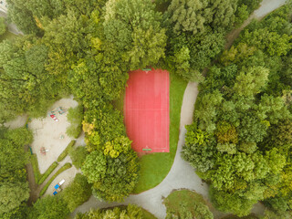 Poster - Drone shot of an outdoor basketball court and a playground in a park