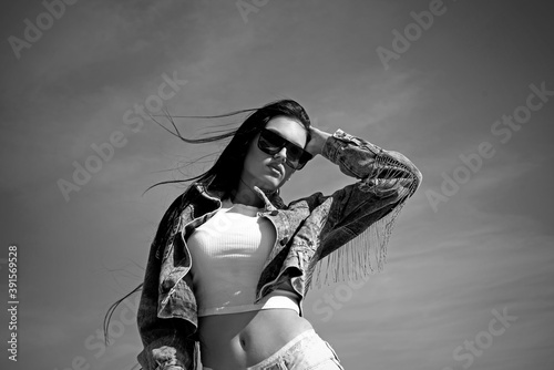 Fotografía Sexy girl wearing style jacket and underwear posing and looking into the camera isolated in sky over beautiful sunset