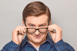 © Andrei Korzhyts - Portrait of happy blond mature man looking over his glasses at you
