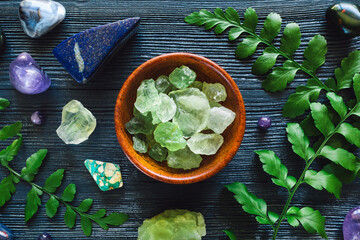 Wall Mural - Bowl of Fluorite with Zodiac Stones of Pisces on Blue Background