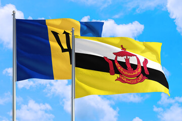 Wall Mural - Brunei and Barbados national flag waving in the windy deep blue sky. Diplomacy and international relations concept.