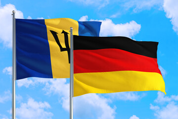 Wall Mural - Germany and Barbados national flag waving in the windy deep blue sky. Diplomacy and international relations concept.