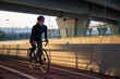 © Алексей Васильев - Evening workout of a woman on a bike. Play sports in the city. Yacht Bridge St. Petersburg.