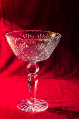 Crystal vase for fruit on a red velvet background.