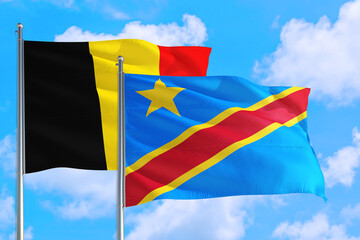 Wall Mural - Congo and Belgium national flag waving in the windy deep blue sky. Diplomacy and international relations concept.