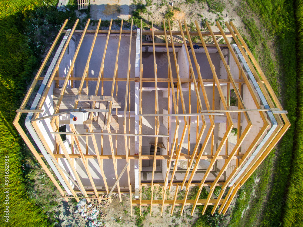 Building Rood Down View Top-down view on house under construction. Wooden roof structure ...