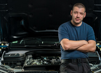 Poster - Mechanic leaning by the hood of a car