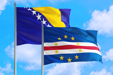 Cape Verde and Bosnia Herzegovina national flag waving in the windy deep blue sky. Diplomacy and international relations concept.