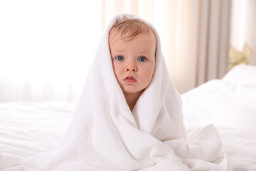 Canvas Print - Cute little baby with soft towel on bed after bath