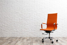 Comfortable Office Chair Near White Brick Wall Indoors. Space For Text