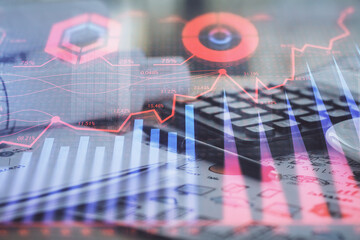 Double exposure of financial chart drawings and desk with open notebook background. Concept of forex market