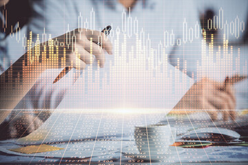 Double exposure of forex graph drawing over people taking notes background. Concept of financial analysis