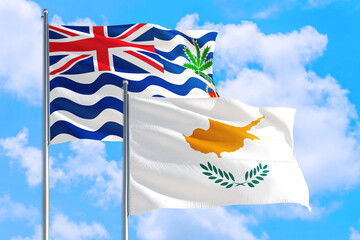 Cyprus and British Indian Ocean Territory national flag waving in blue sky. Diplomacy and international relations concept.