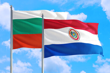 Paraguay and Bulgaria national flag waving in the windy deep blue sky. Diplomacy and international relations concept.