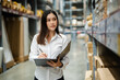 © geargodz - woman worker holding clipboard and checking inventory in the warehouse store