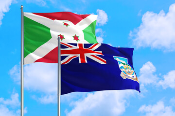 Wall Mural - Falkland Islands and Burundi national flag waving in the windy deep blue sky. Diplomacy and international relations concept.