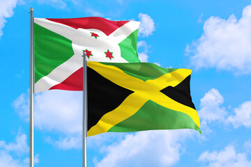 Wall Mural - Jamaica and Burundi national flag waving in the windy deep blue sky. Diplomacy and international relations concept.