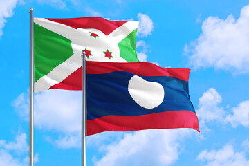 Wall Mural - Laos and Burundi national flag waving in the windy deep blue sky. Diplomacy and international relations concept.