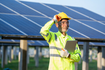 Poster - Supervisor Engineers men wearing safety vest and safety helmet standing in front of solar panels,Green Energy Concept.