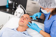 © JackF - Handsome young man receiving procedure of injection contouring for facial correction in cosmetology clinic