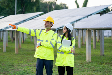 Poster - Engineer Woman Holding Digital Tablet Working Technician in Solar Panels Power Farm,Green Energy Concept.