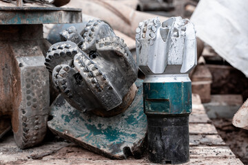 Wall Mural - Close up view on drill bit roller cutter for drilling machines and equipment for oil and gas industry. Modern drill bits with diamond and composite teeth.