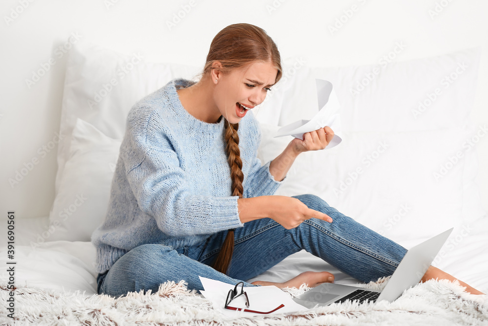 Stressed young woman working at home