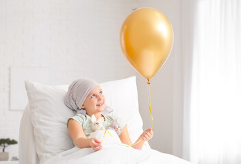 Sticker - Little girl with golden balloon undergoing course of chemotherapy in clinic. Childhood cancer awareness concept