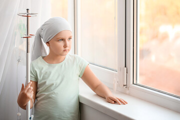 Little girl undergoing course of chemotherapy in clinic