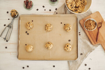 Canvas Print - Top view of chocolate chips dough balls on an oven tray