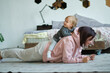 © yavdat - young mom does the plank when her daughter sits on her back