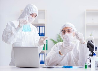 Two scientists working in the chemical lab