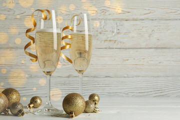 New year concept with glasses of champagne on white wooden background